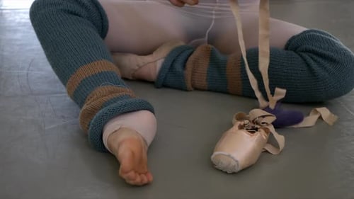 Female Ballet Dancer Stretching Ballet Shoes on Floor in Dance Studio 2024 Years