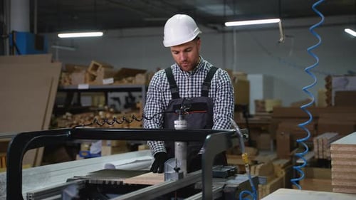 Worker Drilling Wood Board at Furniture Factory