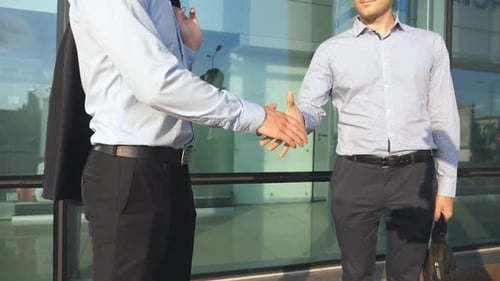 Three Unrecognizable Businessmen Greeting Each Other in Urban Environment