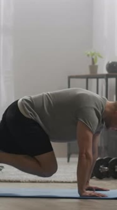 Man Doing Mountain Climber Exercise on Yoga Mat