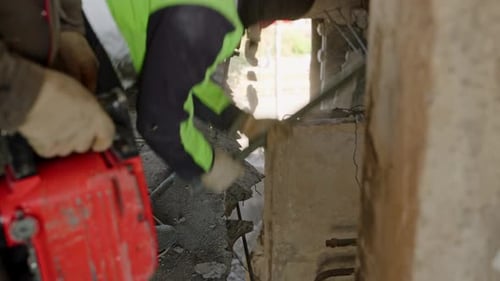 Construction Workers Demolish Wardamaged Walls Ceilings in Burned Apartment Using Jackhammers