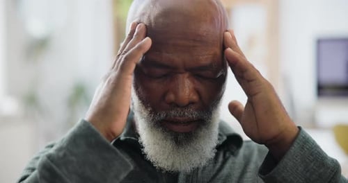 Senior Man with Headache Massaging Temples