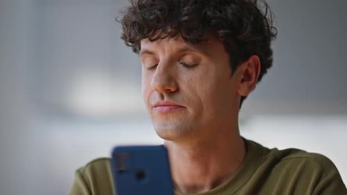 Thoughtful Freelancer Chatting Online Looking Smartphone Screen Office Closeup