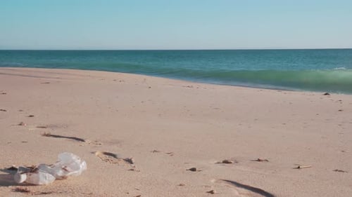 Plastic garbage in a sandy beach of Spain.