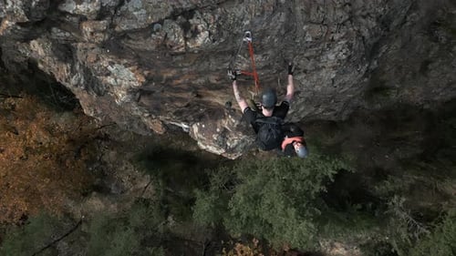Close Top to Bottom Drone Shot of Group of Climbers Climb Up the Cliff