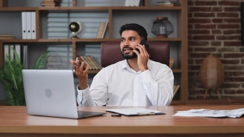 Young Adult Talks on the Phone and Writes Notes