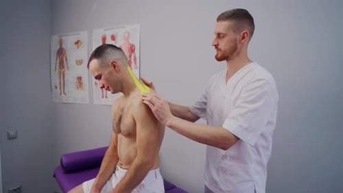 Medical Professional Applies Strip to Patient's Neck and Shoulder