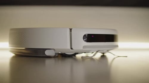 Side View of Robotic Vacuum Cleaner on the Floor
