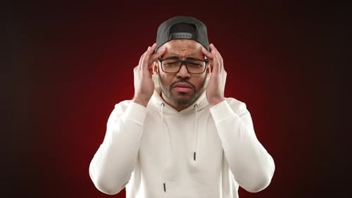 Young Man Suffering From a Severe Headache or Migraine