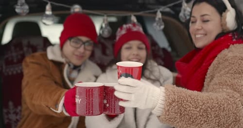 Family Sitting in a Car Among Winter Forest