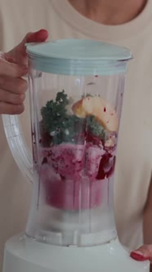 Woman Blending Fruits for Smoothie