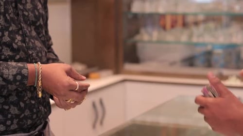 Closeup of hands buying gold ring, giving money and thanking him for great business, Concept showing