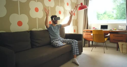 Man on Couch Wearing VR Headset