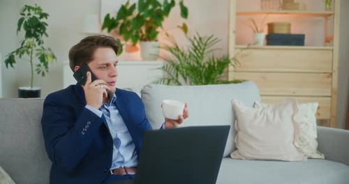 Young Adult on Couch, Talking on Mobile Phone