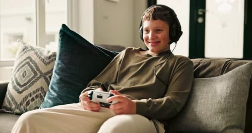 Boy Playing Video Games at Home on the Couch