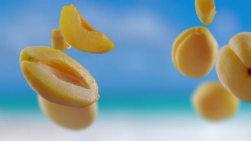 Flying Apricot and Apricots Slices in Beach Tropical Summer Background