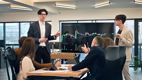 Two young workers leading business meeting in an office, discussing the topic of cryptocurrencies wi