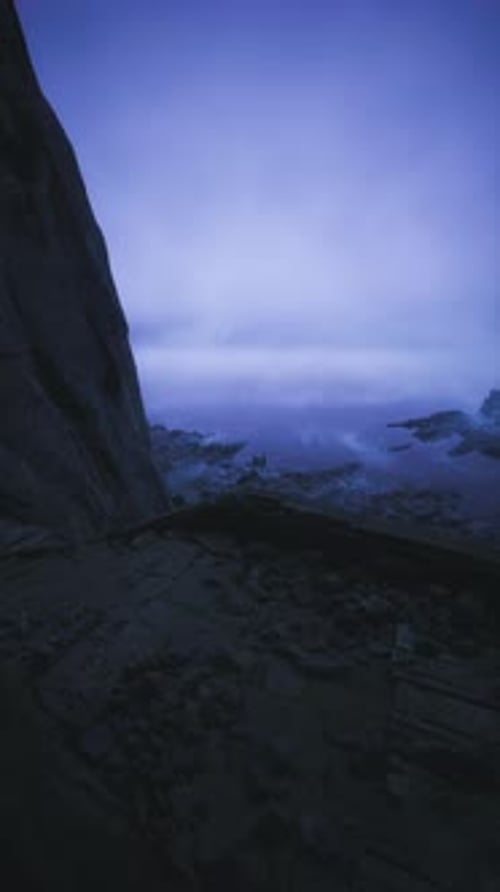 Mysterious Twilight By the Rocky Shore with Calm Water and Enchanting Sky