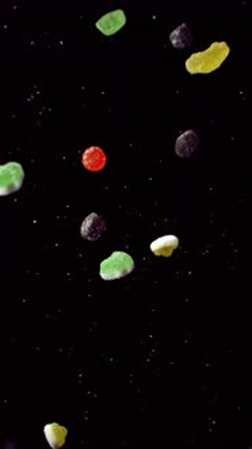 Colorful Gummy Candies Falling on Black Background