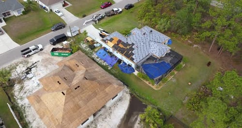 Construction Workers Building House Rooftop with Asphalt Shingles Real Estate Housing Development
