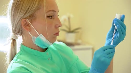 Doctor Filled Syringe with Liquid for Injections Portrait