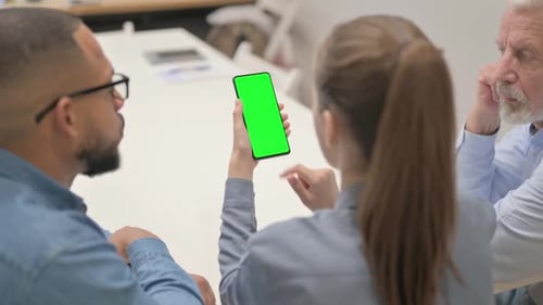 Woman Using Phone with Green Screen During Meeting