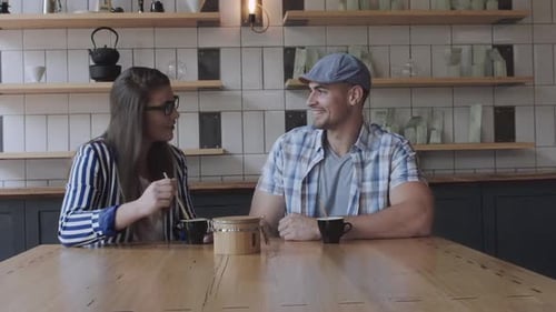 Happy couple enjoying coffee and a first date at a cozy local cafe