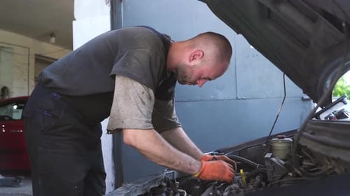 Auto Mechanic Repairs a Car Engine Repair Repair Station