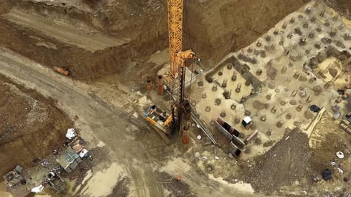 Aerial View of Construction Site with Crane and Workers