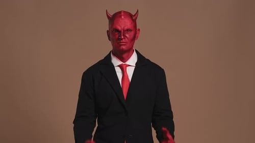 Red Devil Businessman Getting Angry on Solid Background