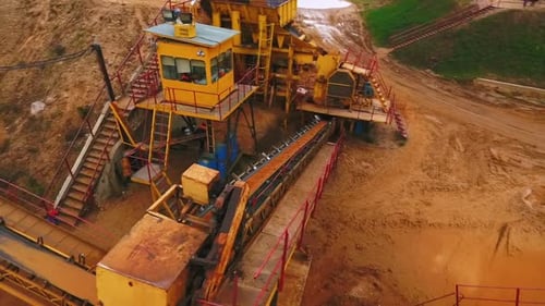 Drone view of sand moving on automatic conveyor belt at sand mine quarry