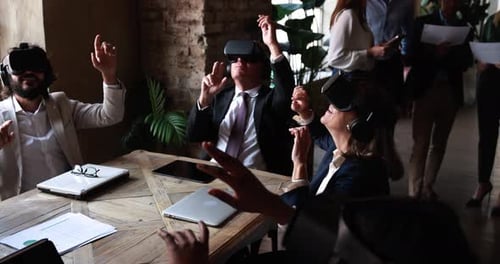 Business people wearing virtual reality goggles inside office