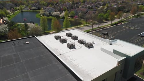 Big Industrial HVAC Air Conditioner System on the Roof on Building Aerial Wide Footage