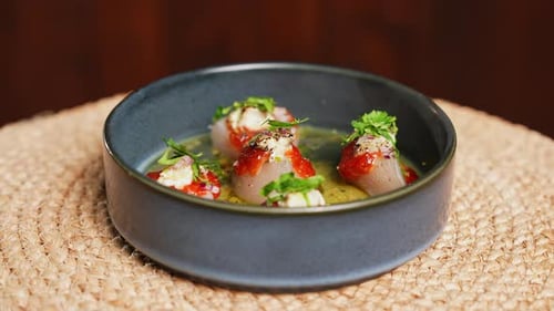 Portion of Seared in Butter Sea Scallops in Grey Bowl