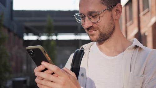 Social Media Influencer Using Cellphone Likes and Comments Posts Outdoor