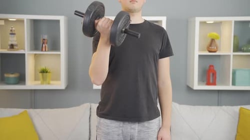 Man Doing Bicep Curls with Dumbbell at Home
