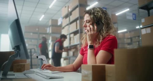 Warehouse Worker on Phone at Desk