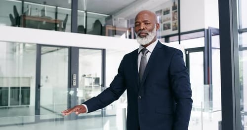 Serious, confidence and a senior business man standing arms crossed in his corporate office