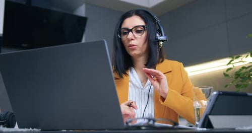 Woman in Blazer Talking During a Video Conference