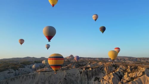 Hot Air Balloons Rise Over Cappadocia Landscape