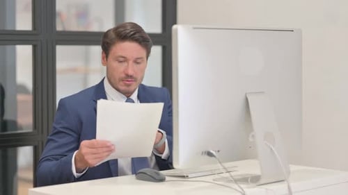 Professional Man Working at Computer in Office