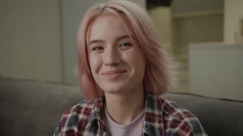 Smiling Young Adult with Pink Hair and Braces