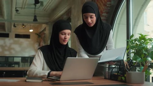 Two Women Working Together at Office Desk