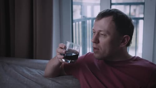 Man Drinking Red Wine While Relaxing at Home