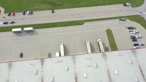 Aerial view of logistics center, warehouses near the highway. Traffic