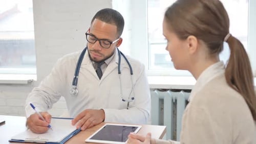 Doctor Consulting with Woman in Bright Office