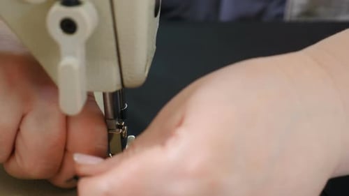Designer Sews Fabric in Atelier Sewing Workshop