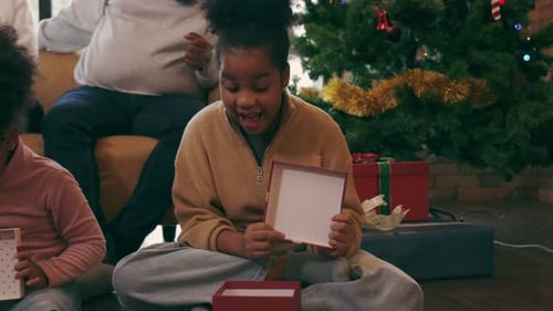 African American family unpacking Christmas gift