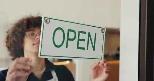 Man, cafe and closed sign on door, small business and storefront or end of service message