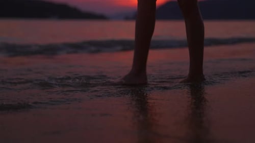 Feet Feeling The Sea Waves On The Shore